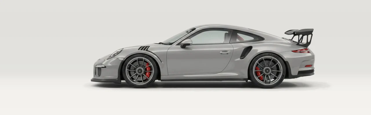 Stüdyo ışığı altında yan profilden gri bir Porsche 911